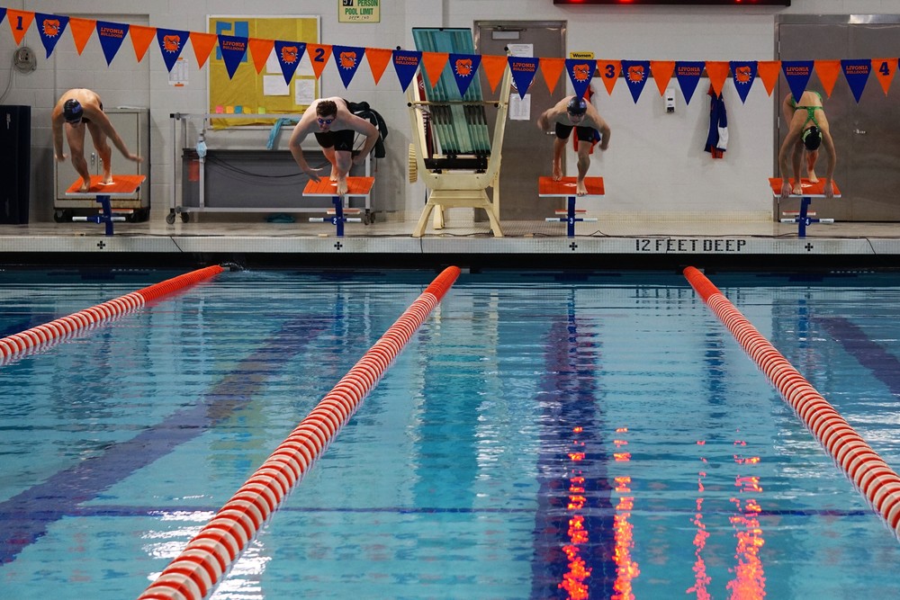 Livonia pool with swimmers going off starting blicks