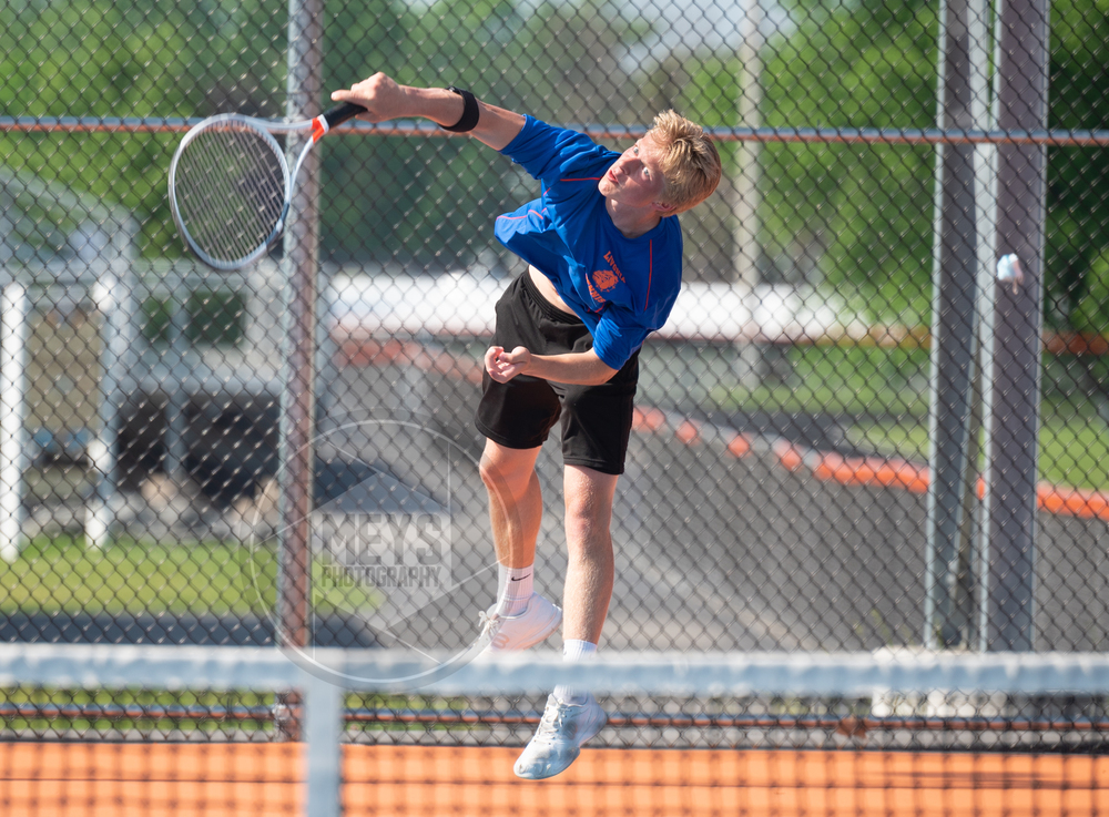 student playing tennis
