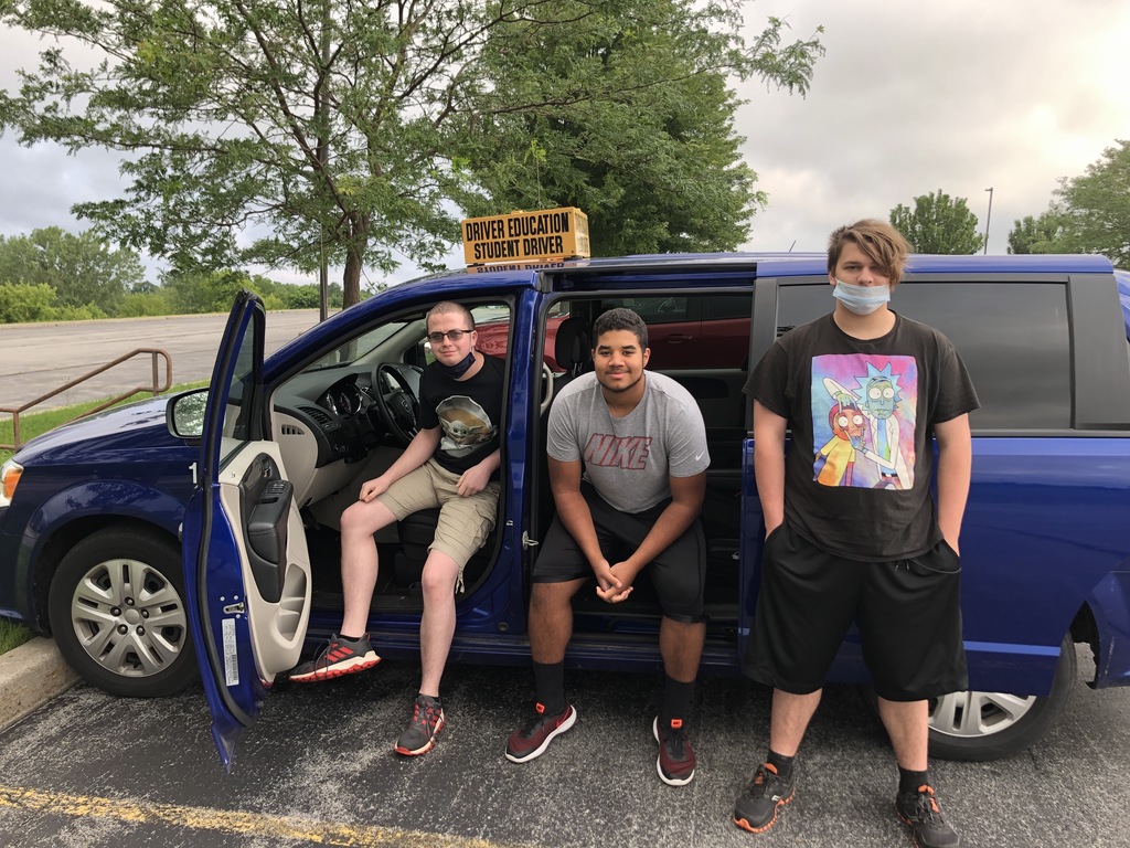 3 students standing in front of drivers ed van
