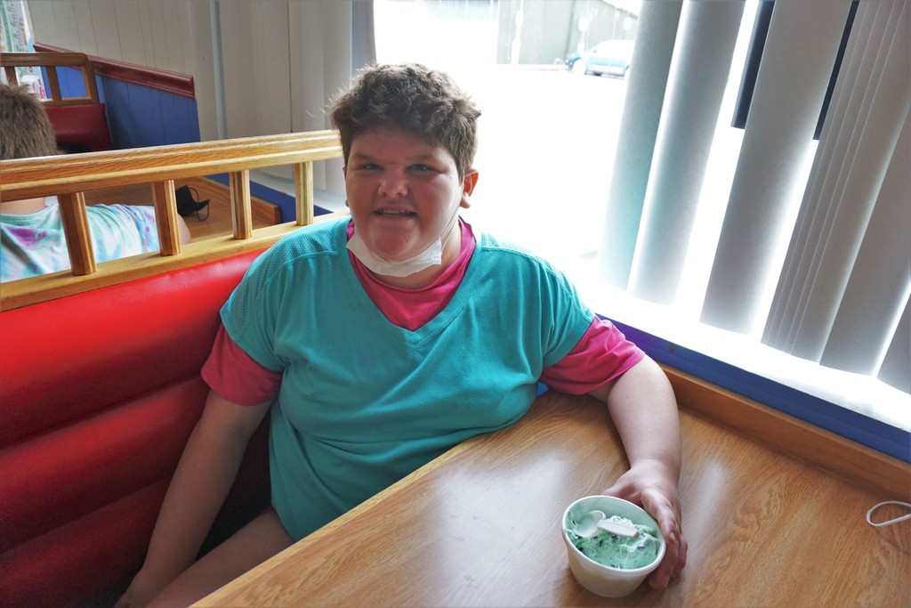 one smiling student enjoying mint ice cream
