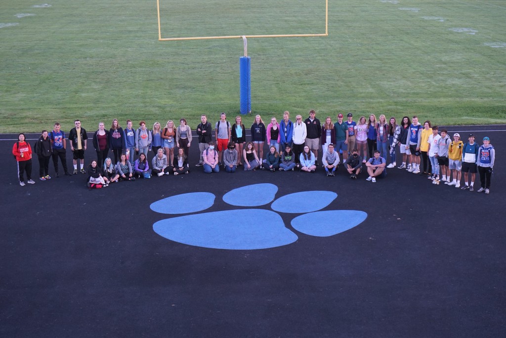 students around paw print in end zone
