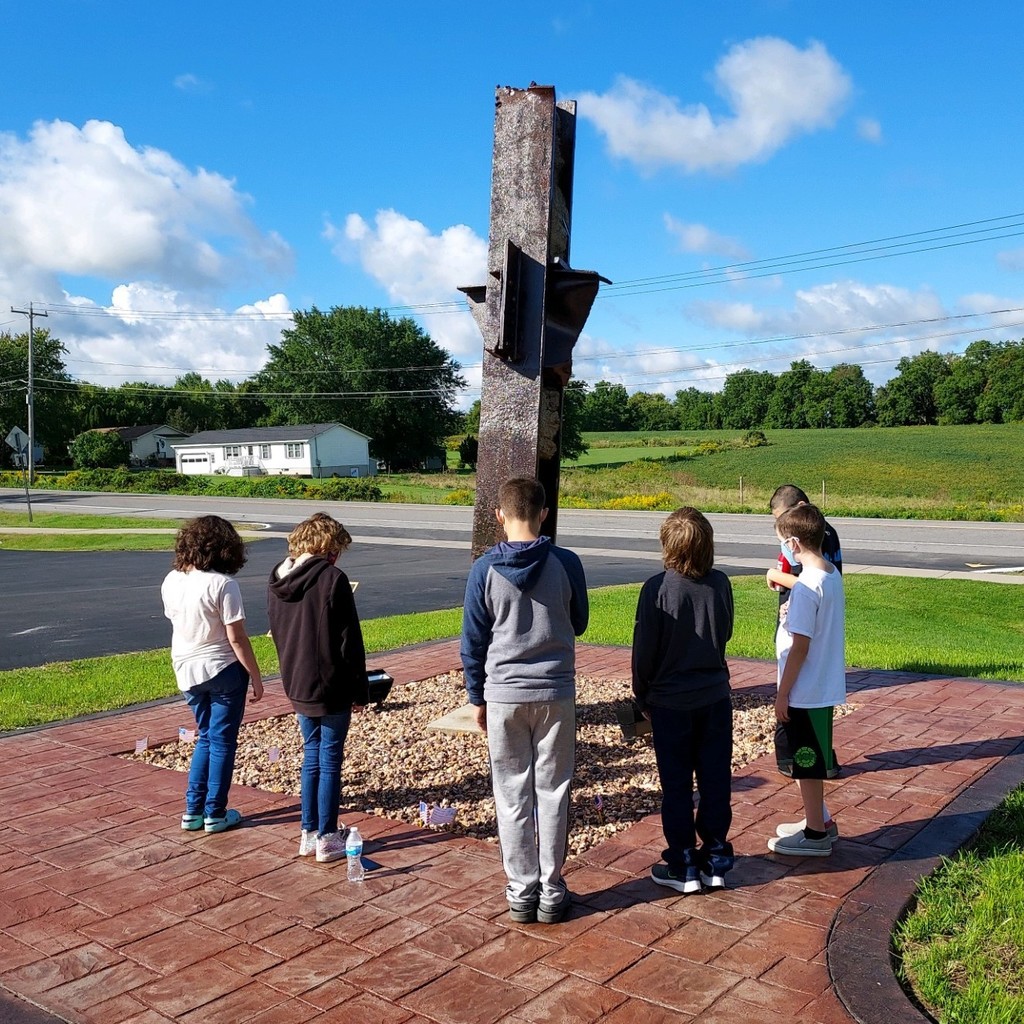 students standing around the 9/11 monument looking at it