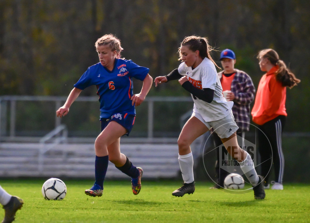 soccer player dribbling ball