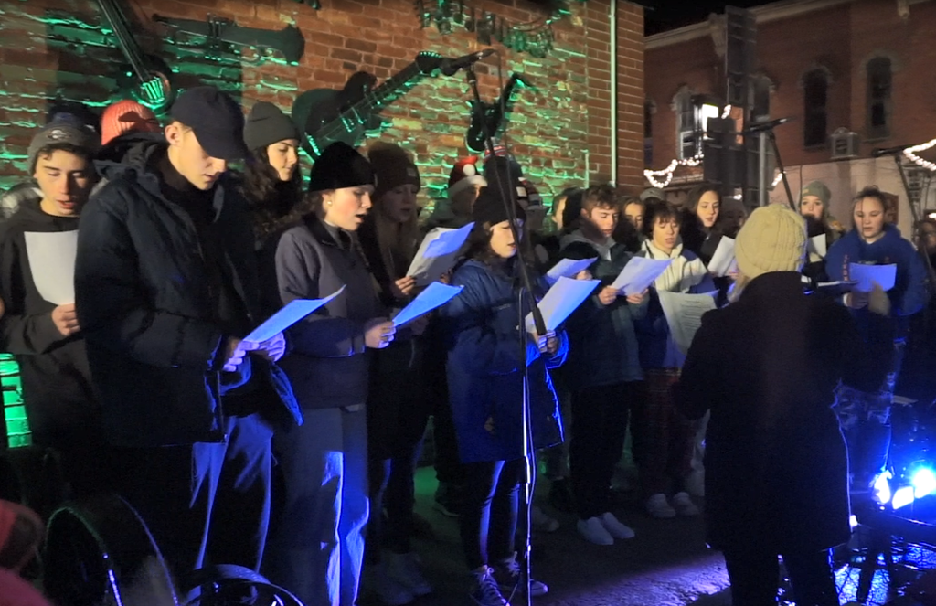 group of students singing outside at tree lighting