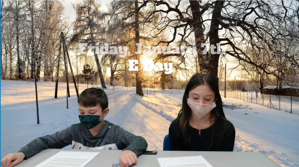 two students at desk with winter scene on green screen