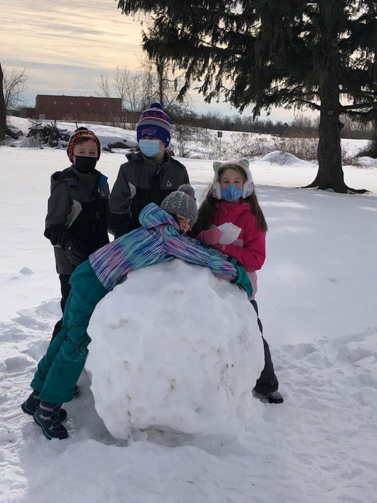 three students and giant snowball