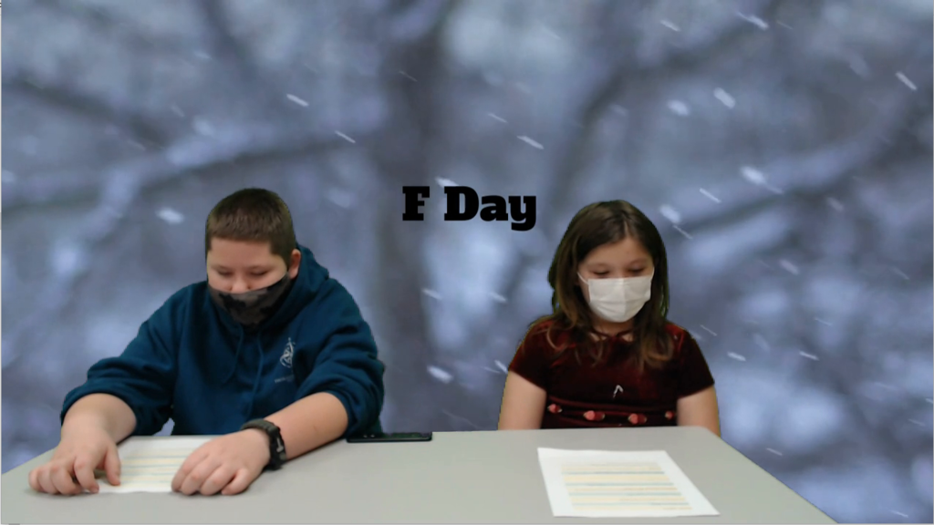 two students at news desk with snow falling on green screen
