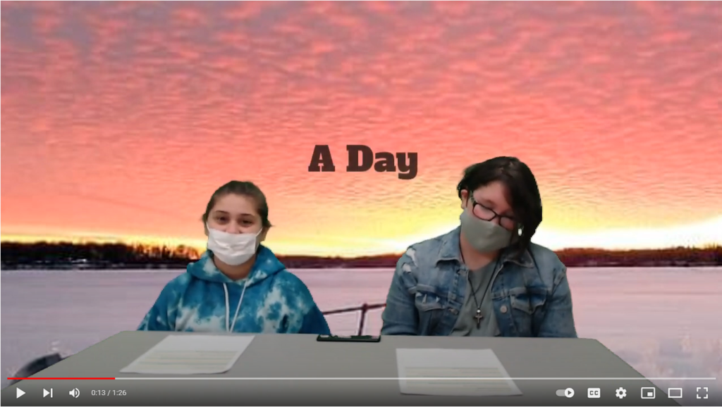two students at desk with sunrise on green screen