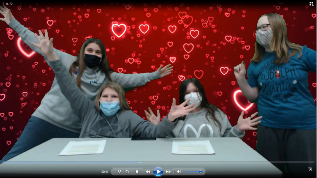 four students cheering with hearts on green screen