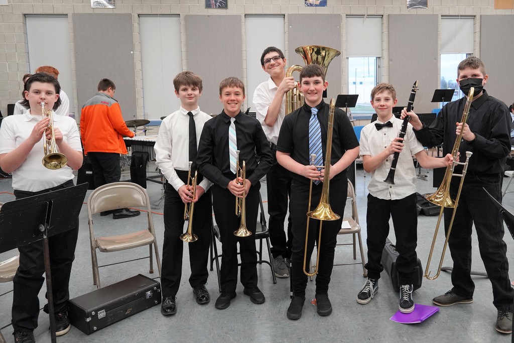 Students in band room with instruments before concert