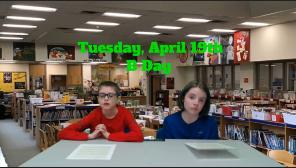 twp students at news table with library on green screen