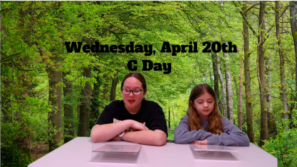 two students at news table with forest on green screen