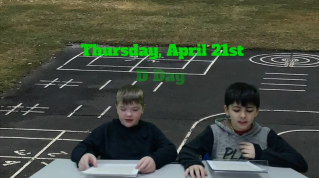 Two students at desk with playground blacktop on green screen