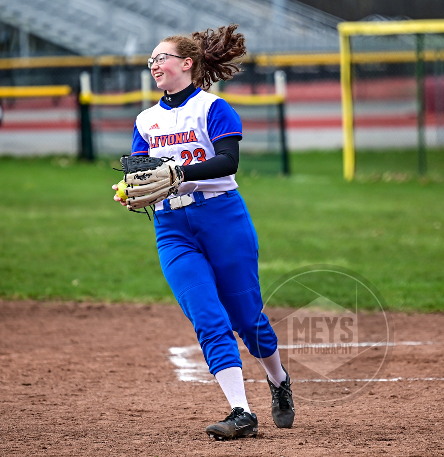 softball player smiling with glove