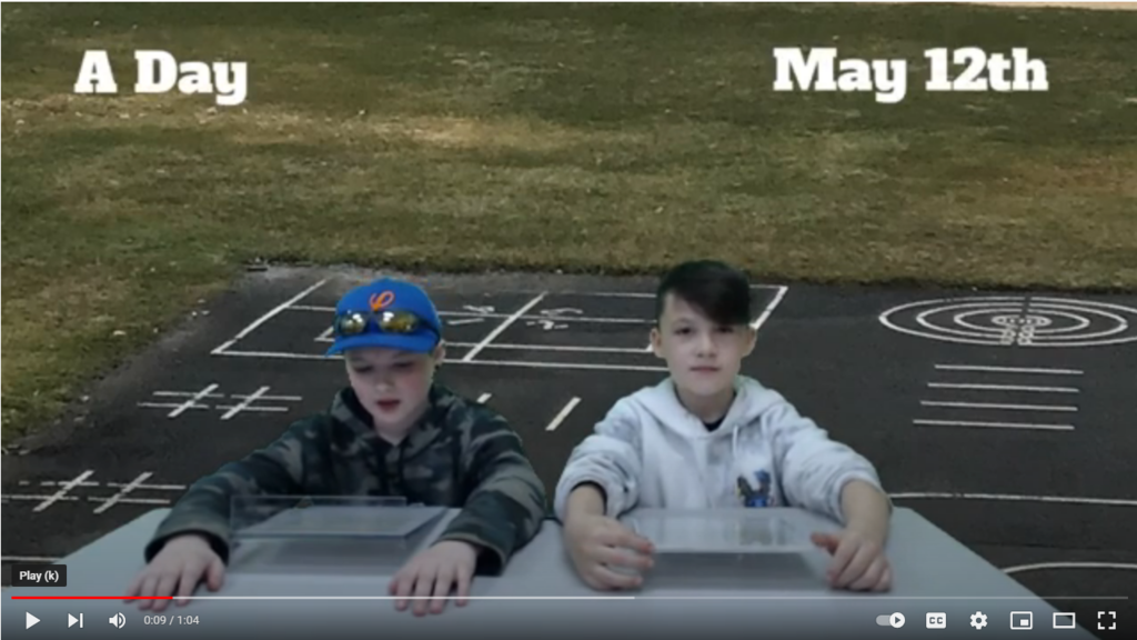 two students at news desk with playground blacktop on green screen