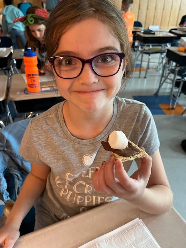 student smiling with smore