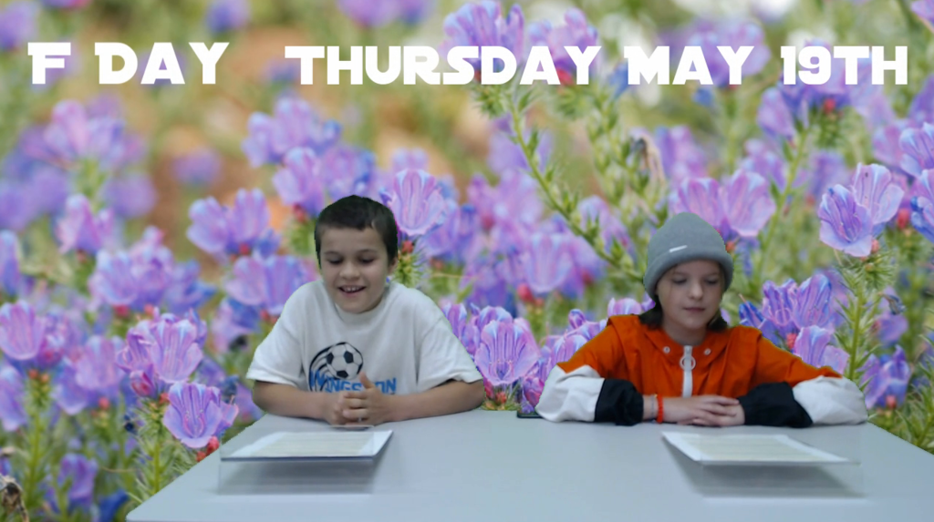 two students at news table with purple flowers on green screen