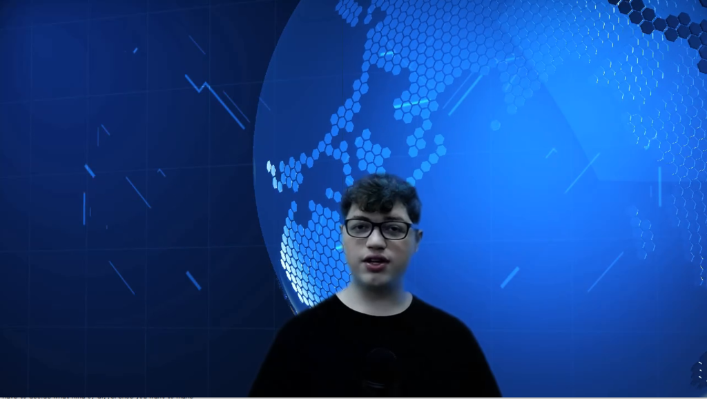 student in front of blue digital earth on green screen