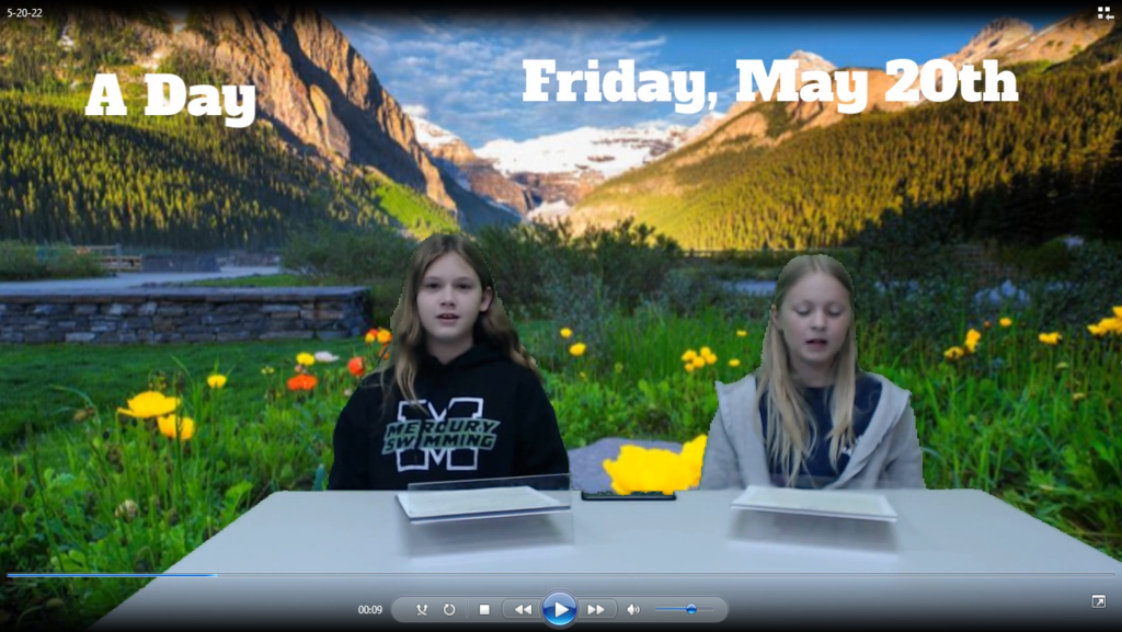 two students at news desk with mountain scene on green screen