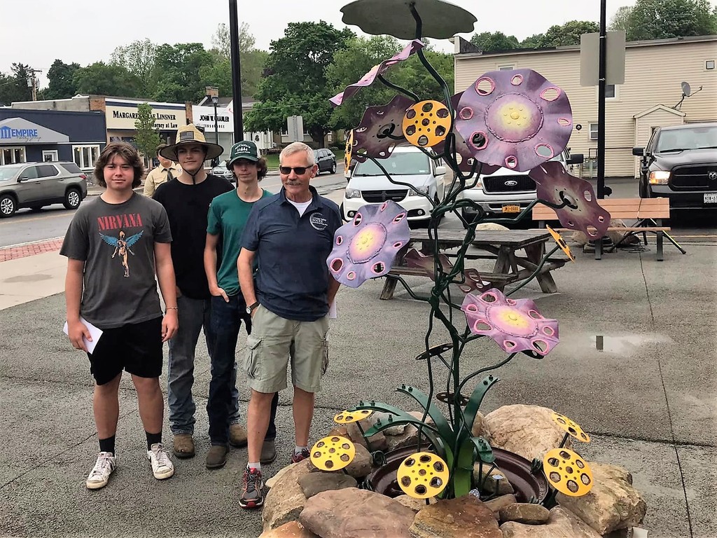 students with metal sculpture