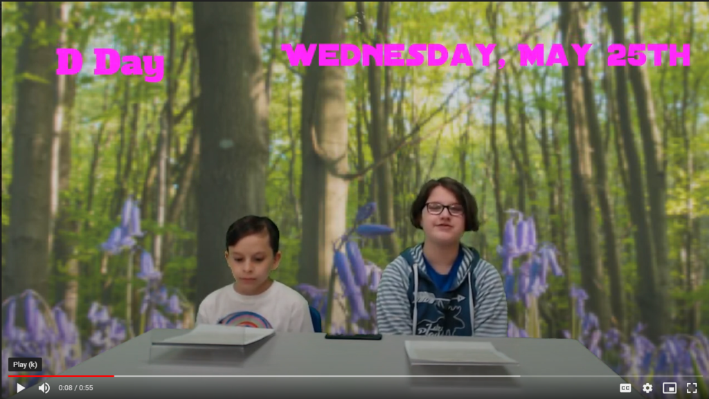 two students at news desk with forest on green screen