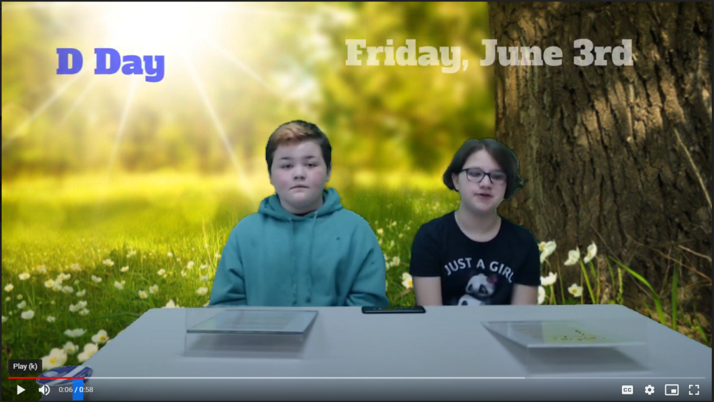 two students at news desk with forest of green screen