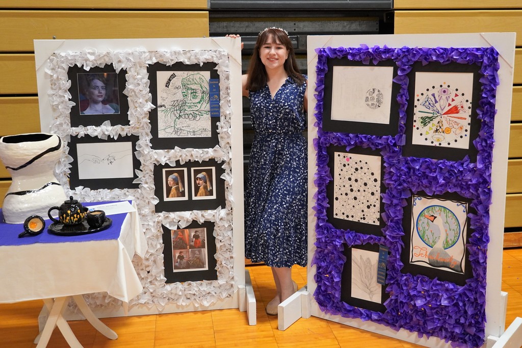 student with art display
