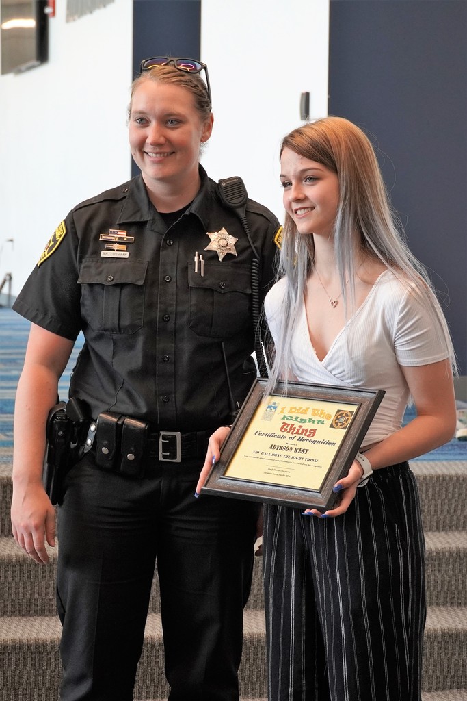 school resource officer giving award to student
