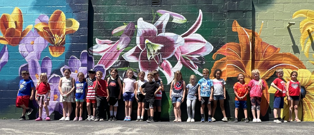 students by wall mural