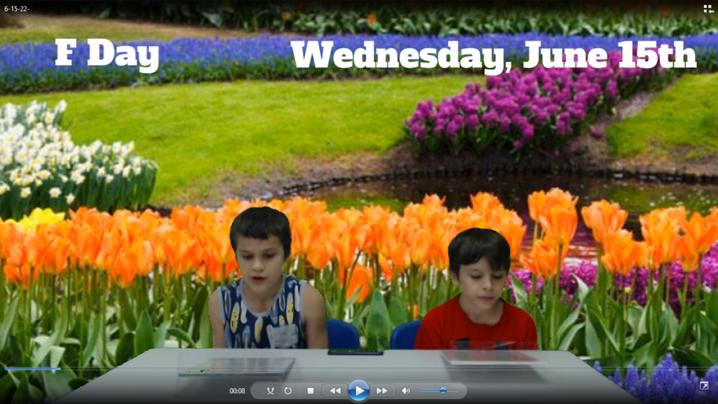 two students at news desk with tulips  on green screen