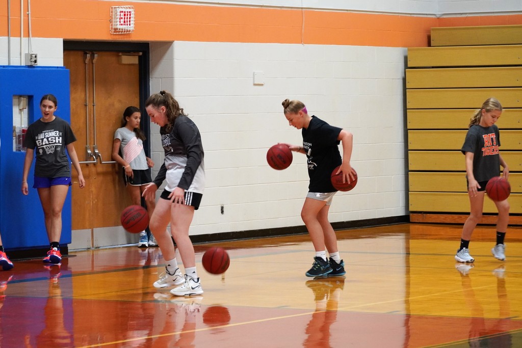 basketball players dribbling with two balls