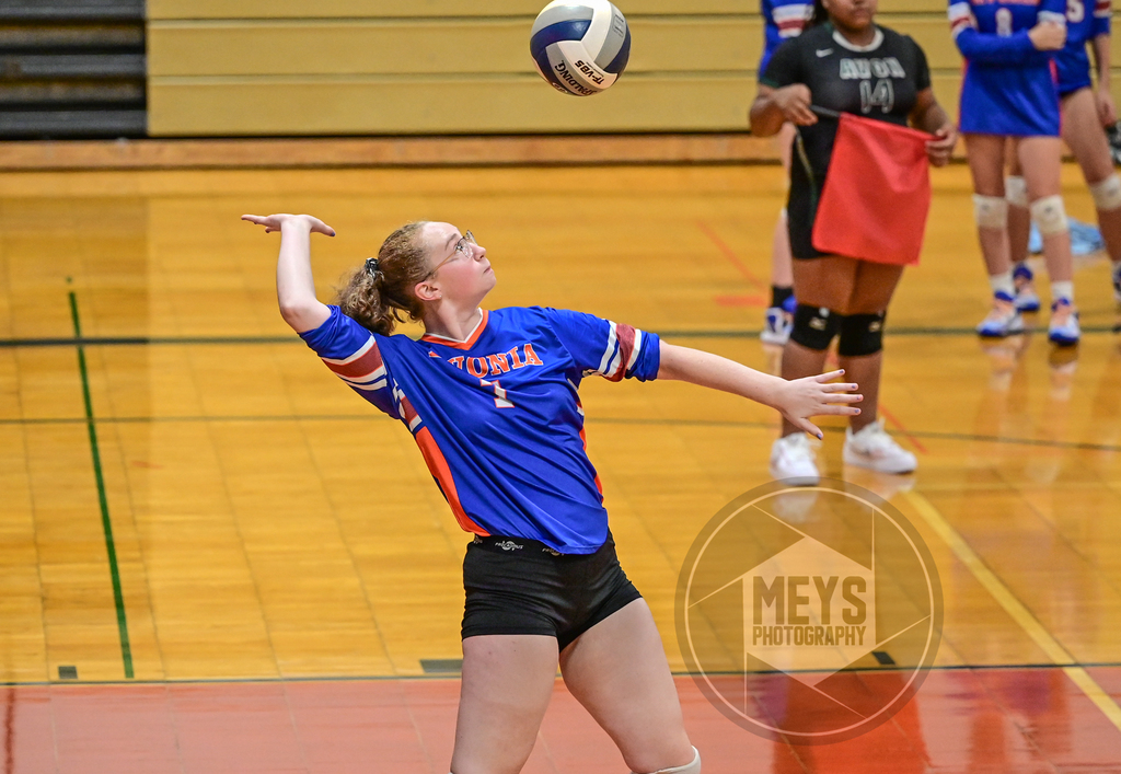 varsity volleyball player serviing