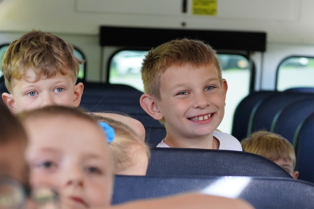 student smiling on bus
