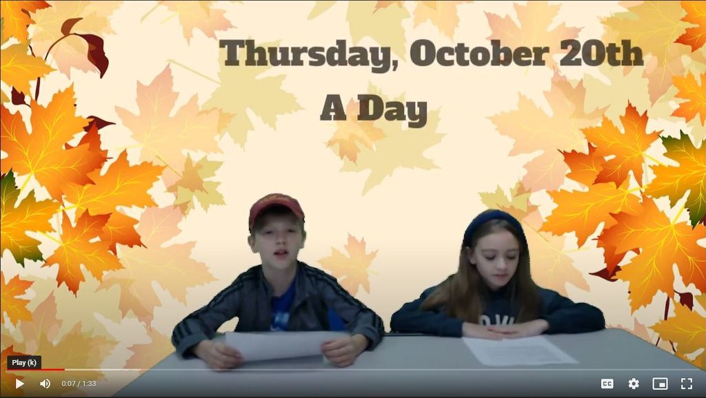 two students at news desk with leaves on green screen