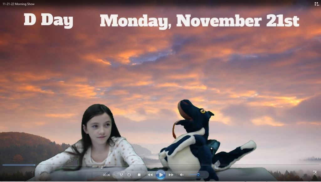 a student and puppet at news desk with sunset on green screen