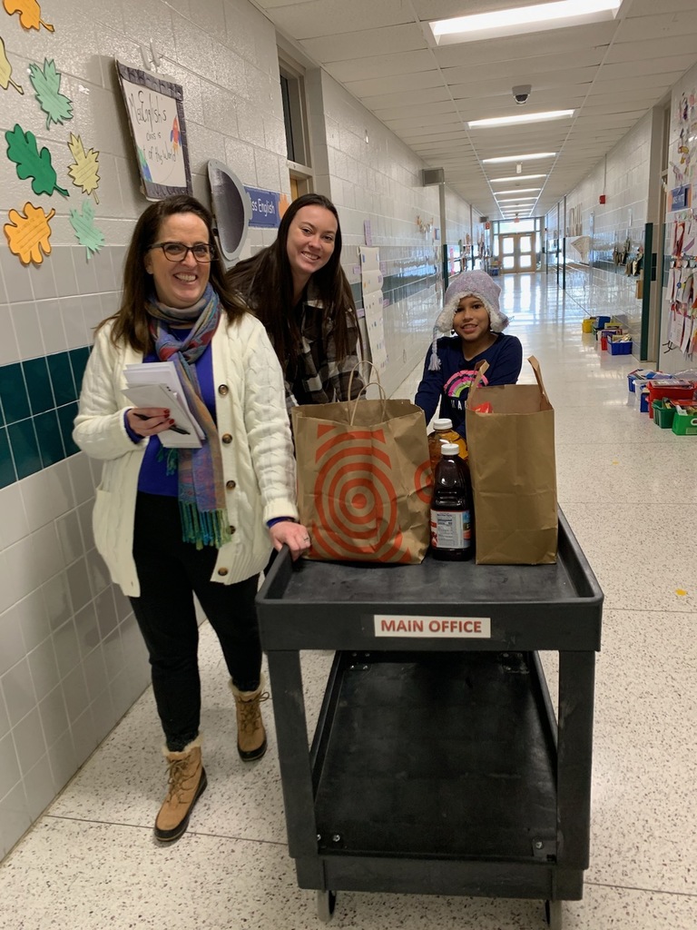 student and staff collecting items with cart