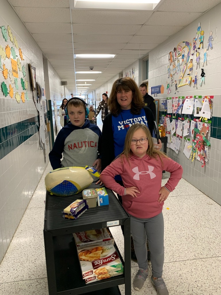 student and staff collecting items with cart