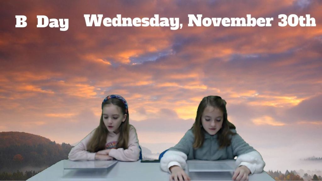 two students at news desk with a sunset sky picture on the green screen