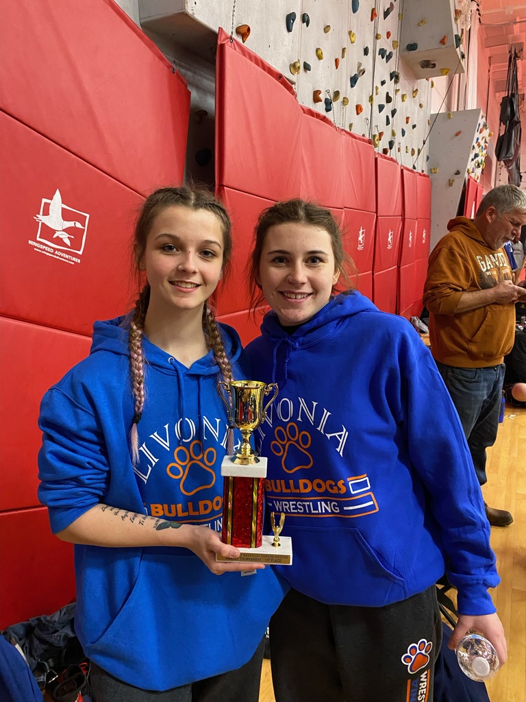 two girls one holding trophy