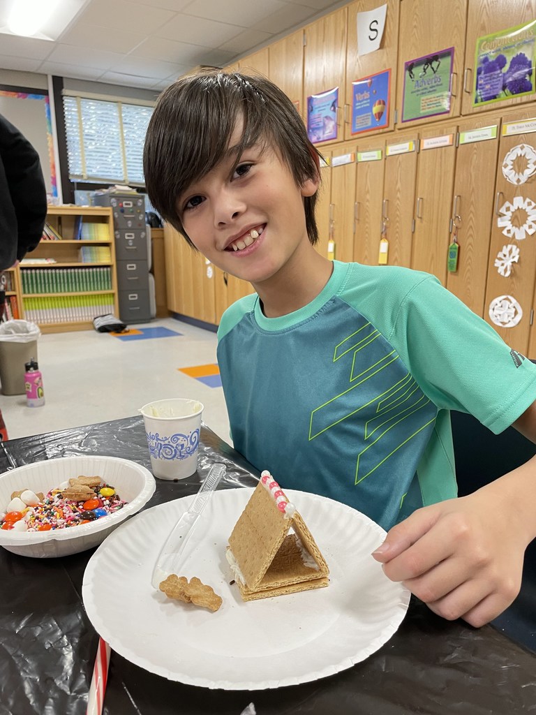 smiling student with graham cracker house