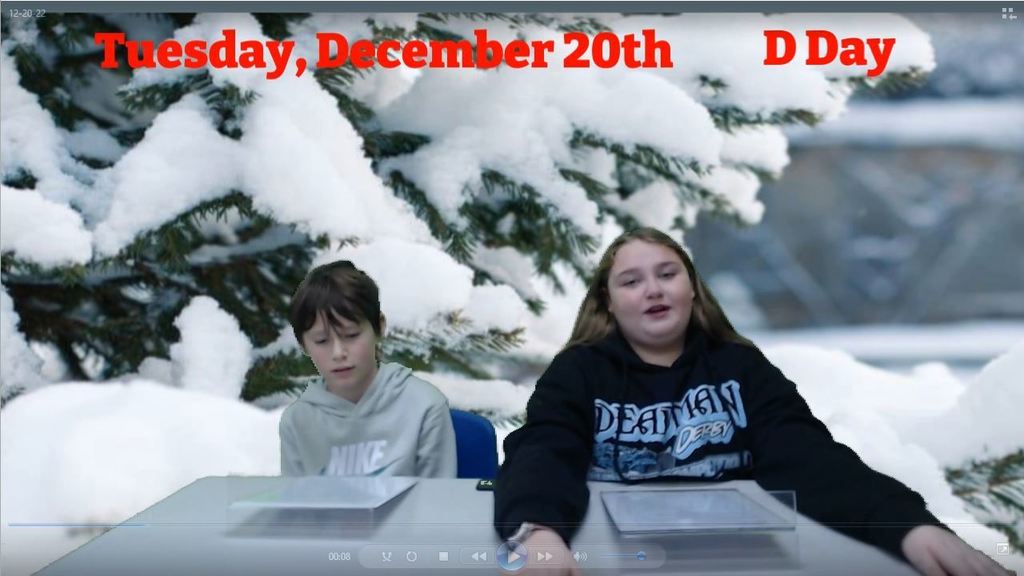 two students at news desk with snowy tree on green screen