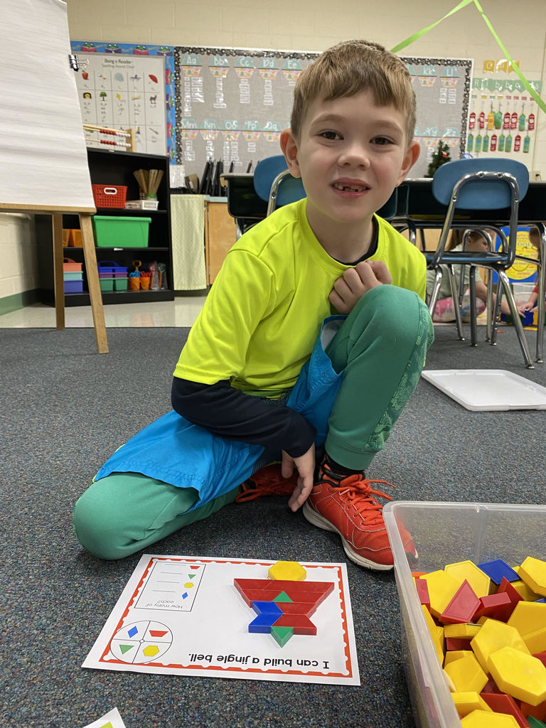 student using pattern blocks to make a winter shape