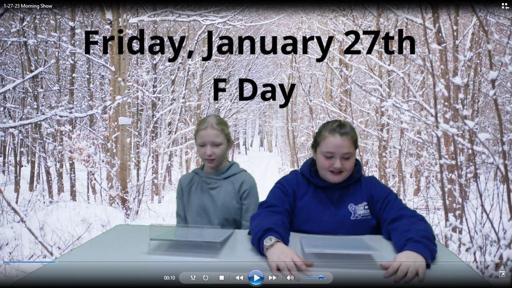 two students at news desk with snowy trail on greenscreen