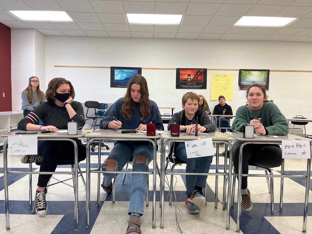 4 students ready for trivia competition