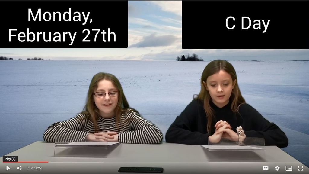 two girls at news desk with snowy field on green screen