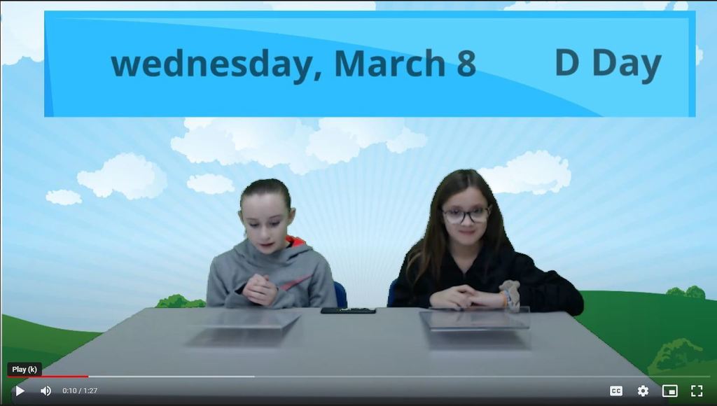 two students at news desk with  landscape graphic on green screen