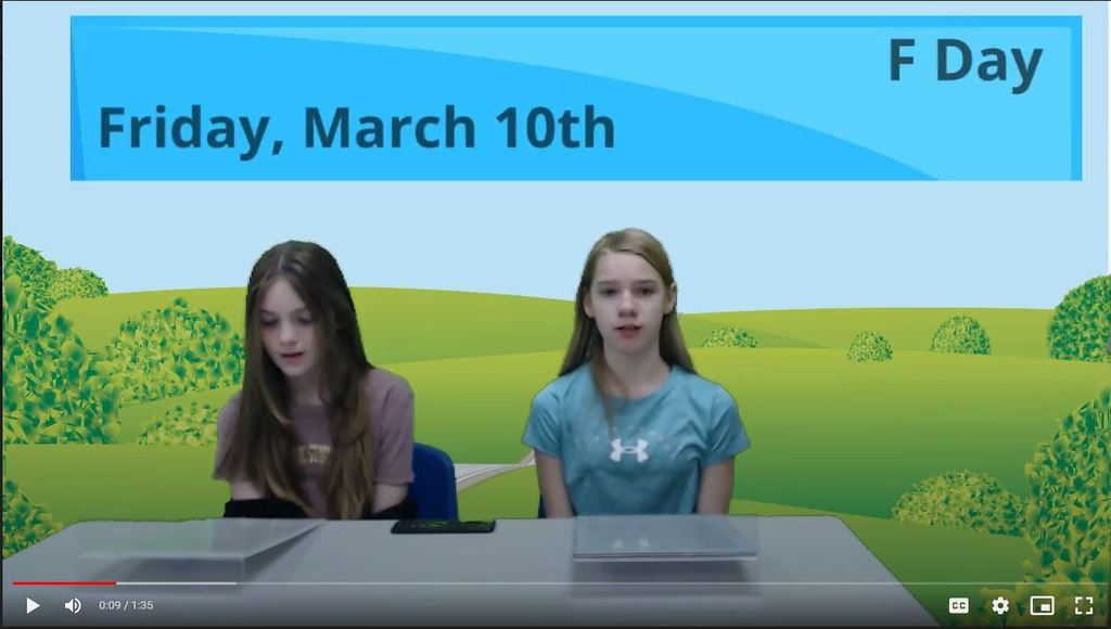 two students at newsdesk with scenic graphic on green screen