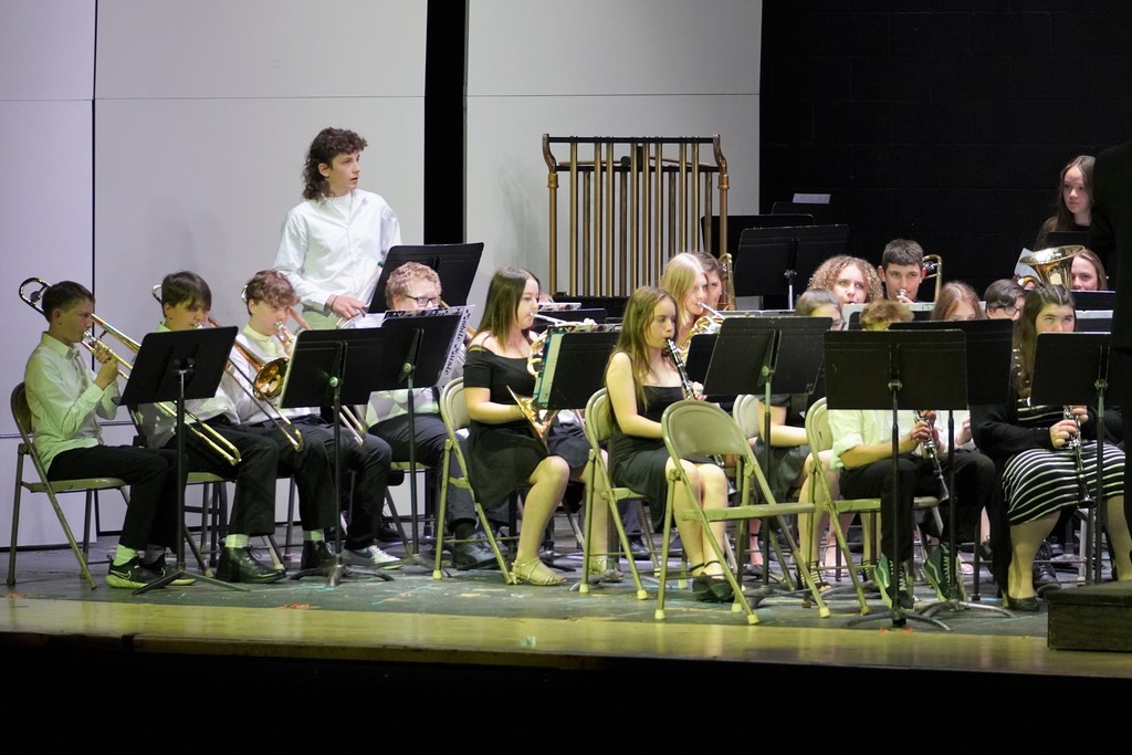 students on stage playing instruments