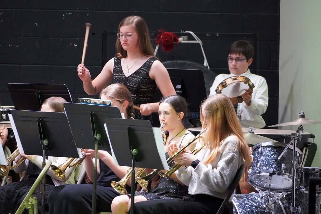 students on stage playing instruments