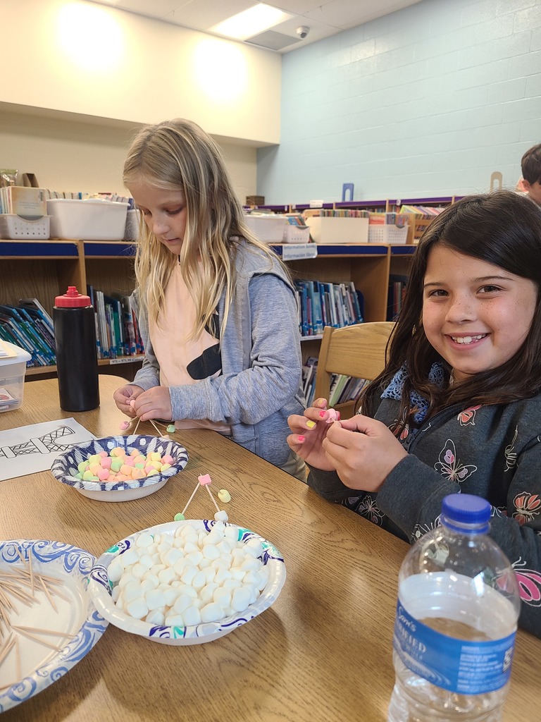 students building the Eiffel Tower with marshmallows and toothpicks